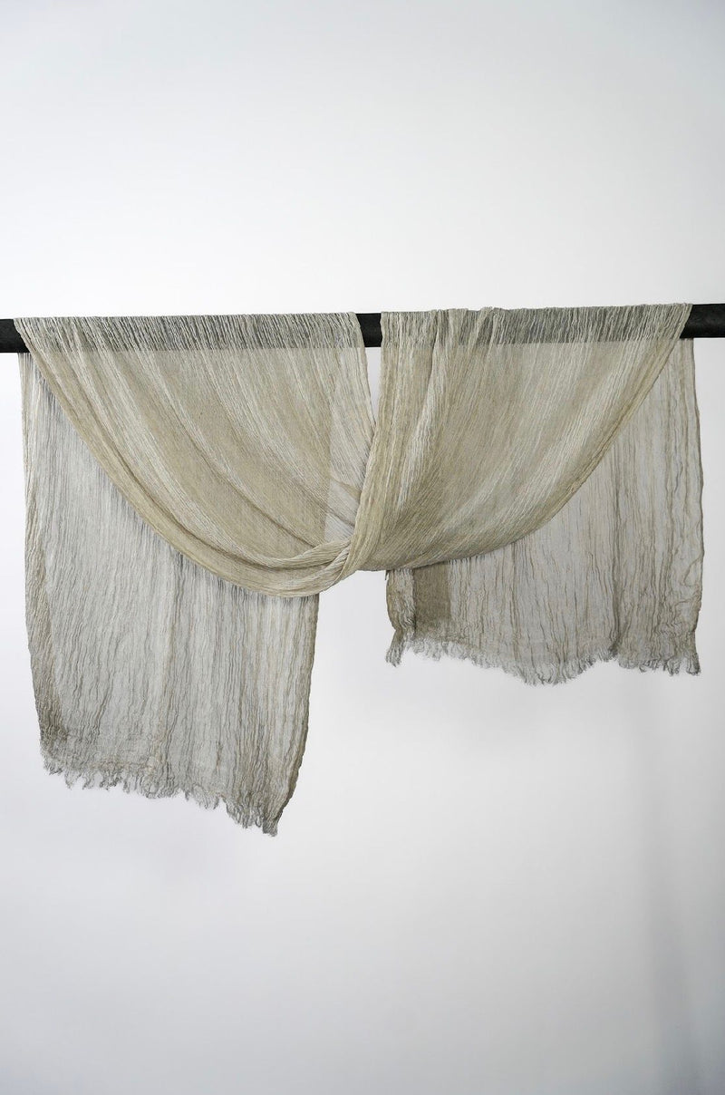 Creshia Oat crinkle hijab draped over a rod