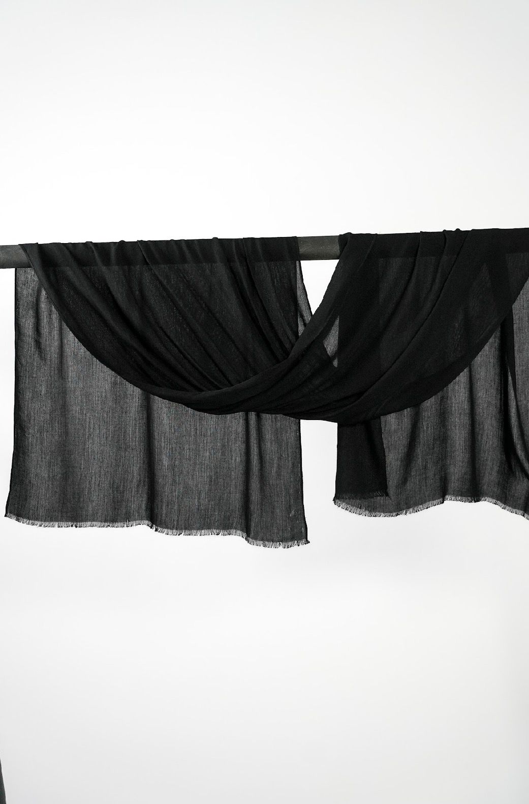 Mélange Deep Black hijab draped over a rod